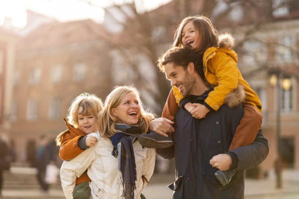 A happy family walking down the street.