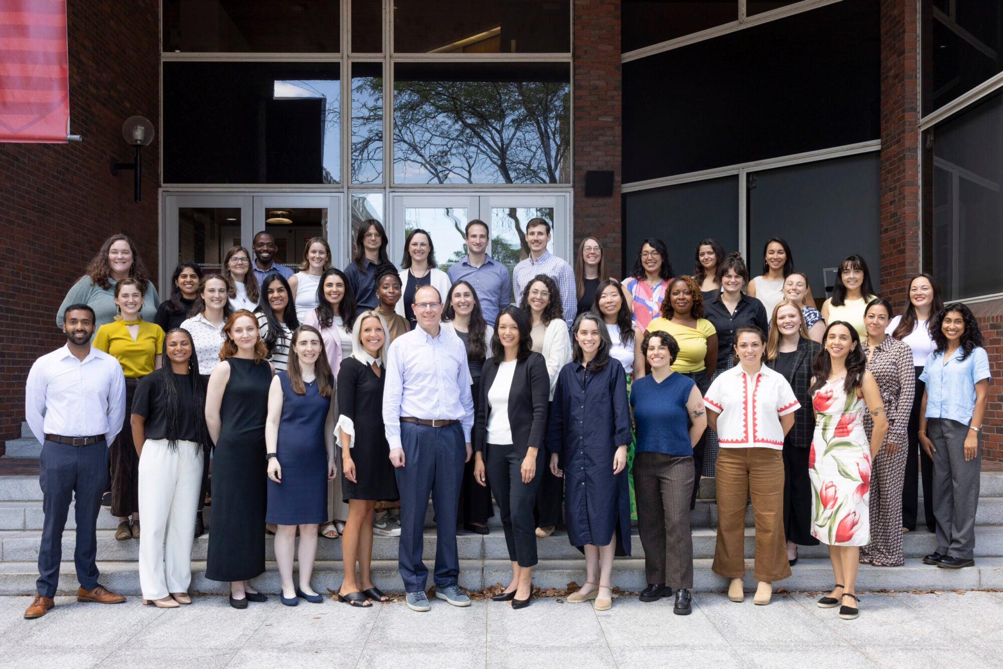 A group photo of the GPL staff standing together on the steps outside the Kennedy School.