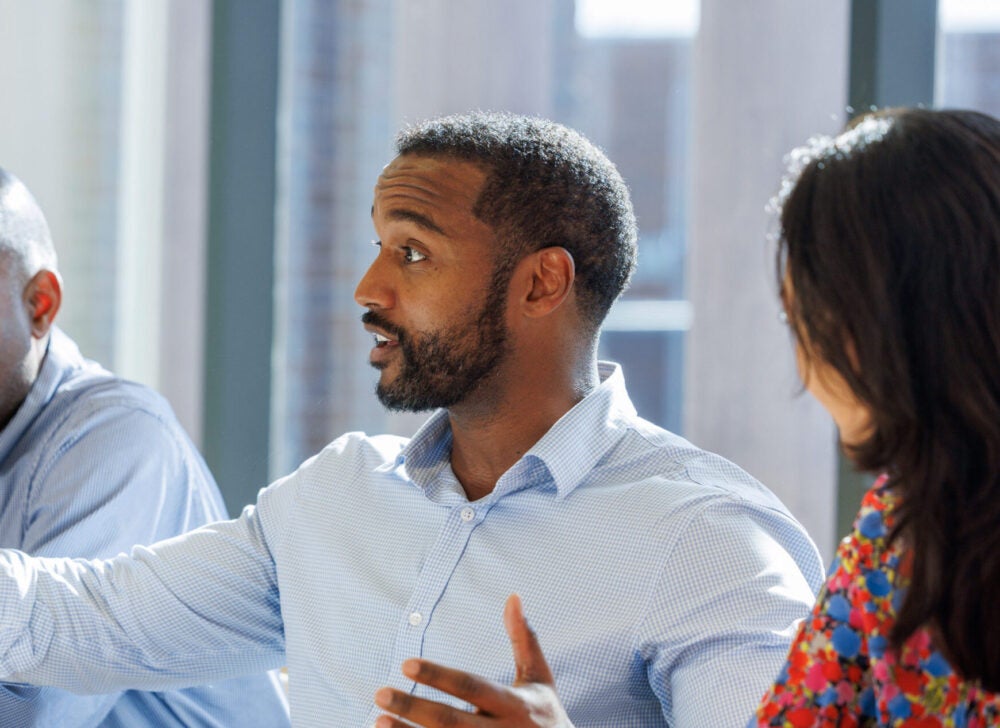 Side profile of a man addressing a room